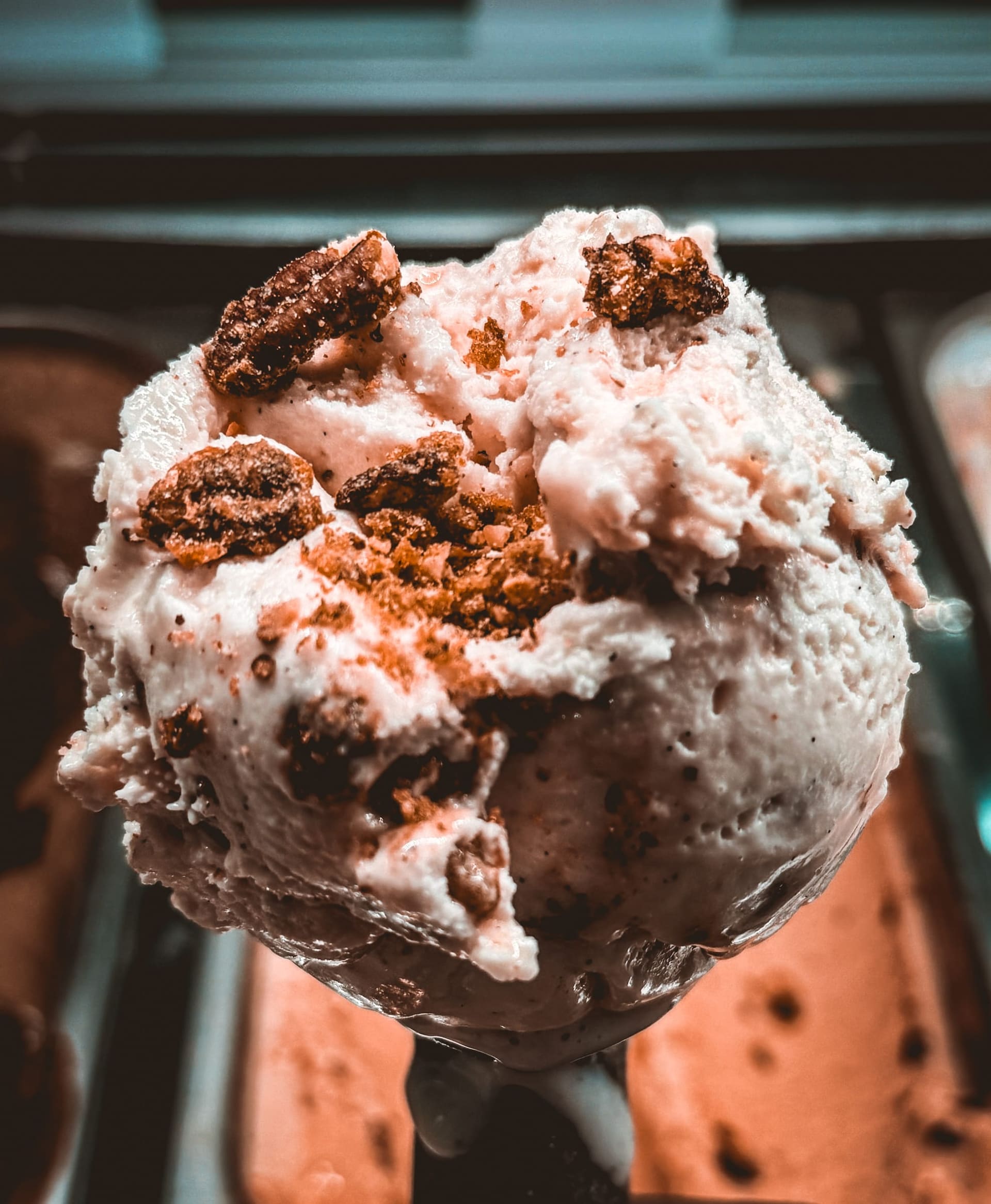 A scoop of Be Free craft ice cream with candied pecans